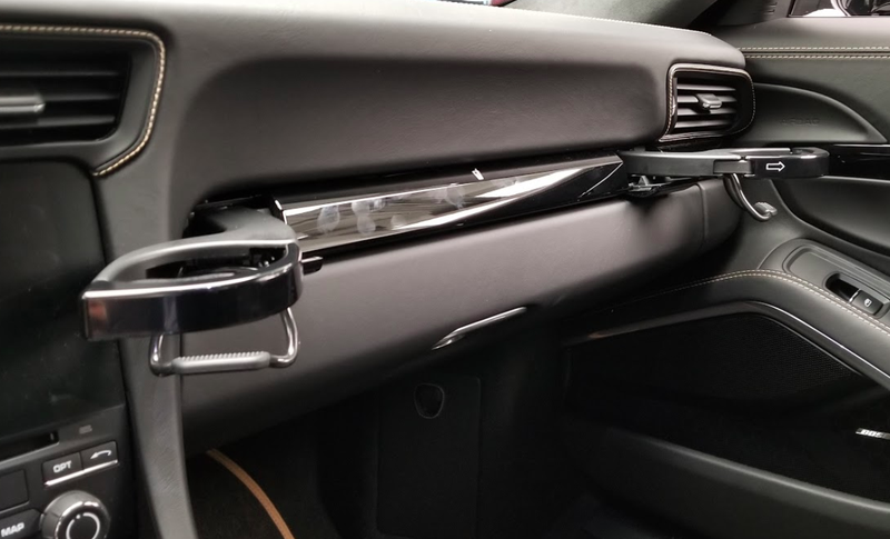 Illustration for article titled The Needlessly Complicated Cupholders in the Porsche 911 Are Awesome